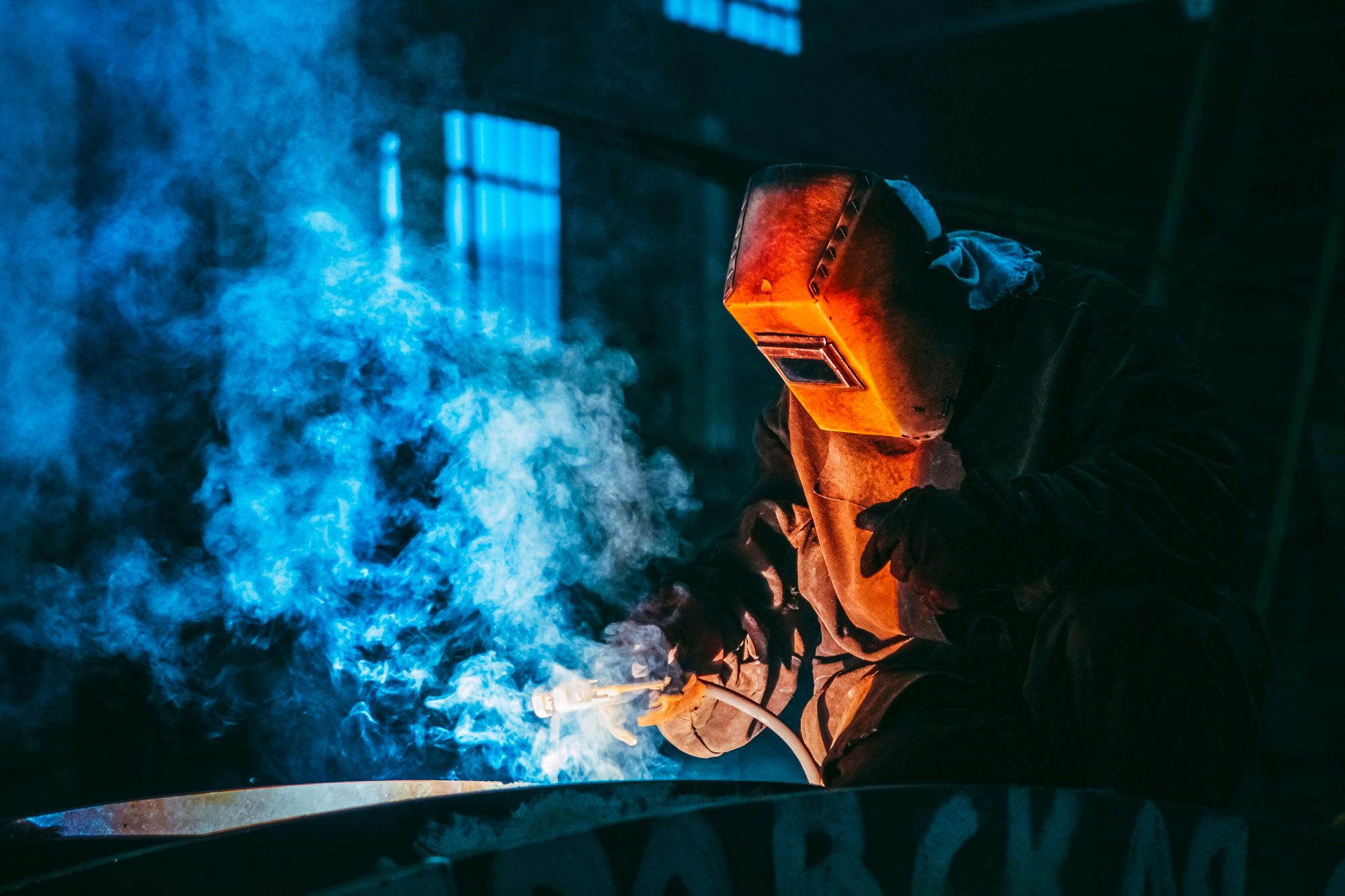 Certified welder performing qualification welding under controlled conditions